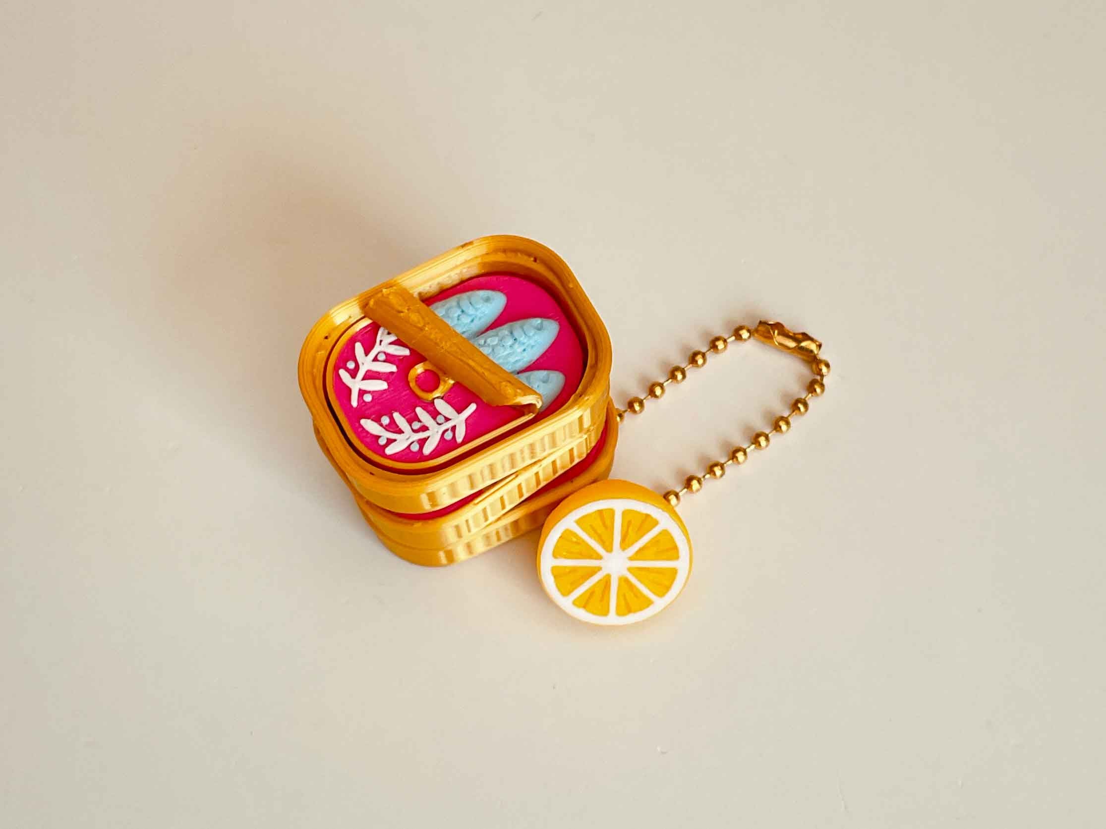Sardine clicker with a little lemon keychain